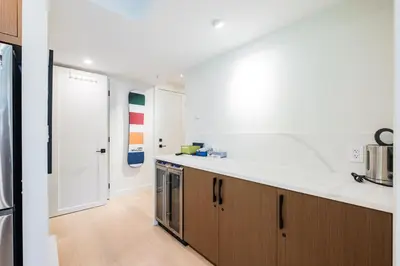 a kitchen with white counter tops and wooden cabinets at Ravencrest by Outpost Whistler in Whistler