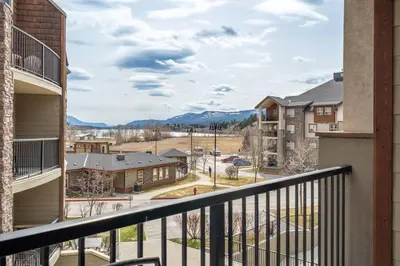 a balcony with a view of a town at Lookout Pointe, Lakeview, Pool, Hot Tub, Gym in Invermere