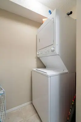 a white refrigerator with a microwave on top of it at Lookout Pointe, Lakeview, Pool, Hot Tub, Gym in Invermere