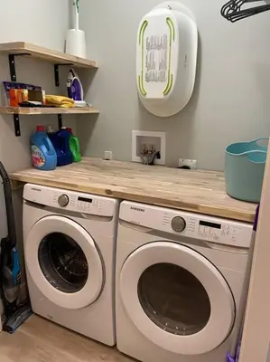 a laundry room with two washing machines and a counter at Ski in Ski Out with Huge Game Room and Hot Tub in Fernie