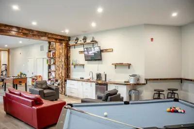 a living room with a pool table at Ski in Ski Out with Huge Game Room and Hot Tub in Fernie