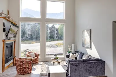 a living room with a couch and a fireplace at Ski in Ski Out with Huge Game Room and Hot Tub in Fernie