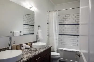 a bathroom with a sink and a toilet and a mirror at Alpenglow Penthouse by Revelstoke Vacations in Revelstoke