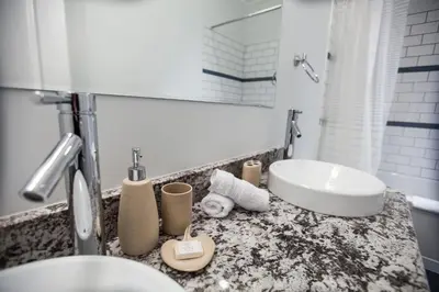 a bathroom with a sink and a toilet and a tub at Alpenglow Penthouse by Revelstoke Vacations in Revelstoke
