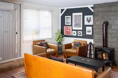 a living room with a couch and chairs and a fireplace at The Downtown Hive by Revelstoke Vacations in Revelstoke