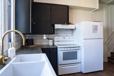 a kitchen with white appliances and a white refrigerator at The Downtown Hive by Revelstoke Vacations in Revelstoke