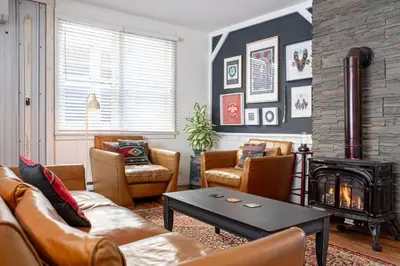 a living room with a couch and a fireplace at The Downtown Hive by Revelstoke Vacations in Revelstoke