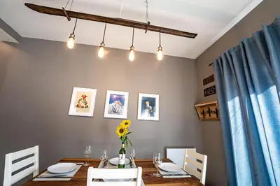 a dining room with a table and a blue curtain at Pillow Top Condo by Revelstoke Vacations in Revelstoke