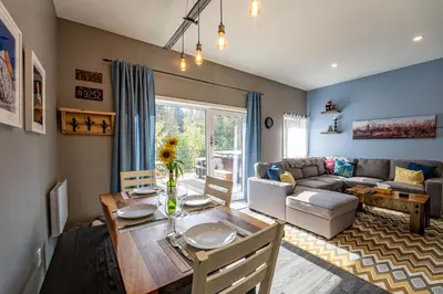 a living room with a table and a couch at Pillow Top Condo by Revelstoke Vacations in Revelstoke