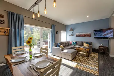 a living room with a table and a couch at Pillow Top Condo by Revelstoke Vacations in Revelstoke