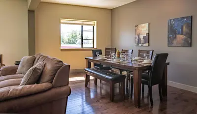a living room with a table and a couch at Selkirk Snug by Revelstoke Vacations in Revelstoke