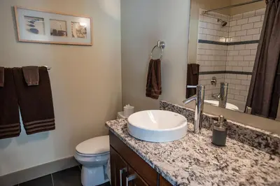 a bathroom with a sink and a toilet at Selkirk Snug by Revelstoke Vacations in Revelstoke