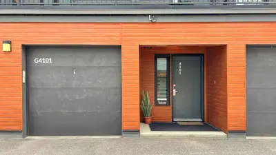 two garage doors on a building with a plant at Al's Escape by Revelstoke Vacations in Revelstoke