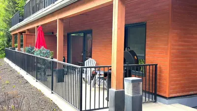 a house with a fence on the side of it at Al's Escape by Revelstoke Vacations in Revelstoke