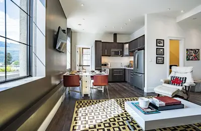 a kitchen and living room with a couch and a table at In the Heart of it All by Revelstoke Vacations in Revelstoke