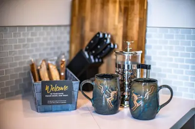 a counter with two coffee mugs on a counter top at In the Heart of it All by Revelstoke Vacations in Revelstoke