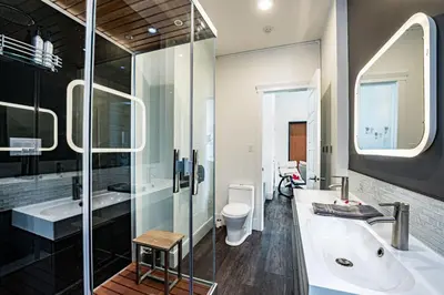 a bathroom with a tub and a shower and a sink at In the Heart of it All by Revelstoke Vacations in Revelstoke