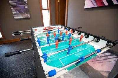 a foosball table with orange paddles in a room at Mackenzie House by Revelstoke Vacations in Revelstoke