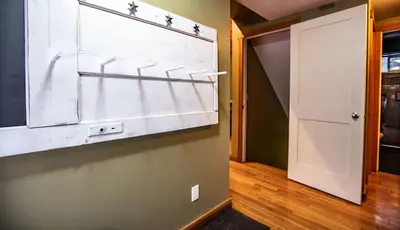 a hallway with a white door and a door at Stoke Cabin by Revelstoke Vacations in Revelstoke