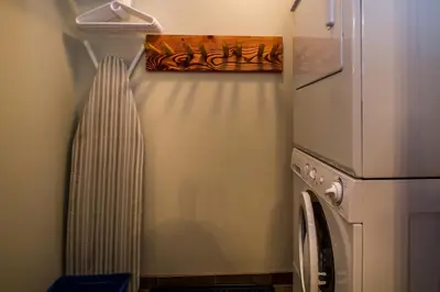 a kitchen with a refrigerator and a washing machine at Give Something Back Retreat by Revelstoke Vacations in Revelstoke