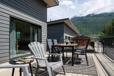 a patio with chairs and a table on a balcony at The Mac Shack by Revelstoke Vacations in Revelstoke