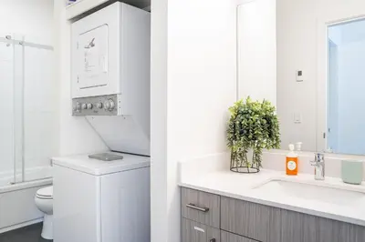 a white bathroom with a sink and a toilet at The Mac Shack by Revelstoke Vacations in Revelstoke