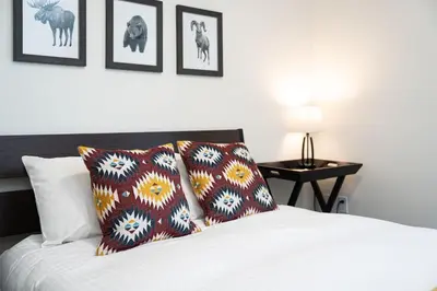 a bedroom with a bed with two pillows on it at The Mac Shack by Revelstoke Vacations in Revelstoke