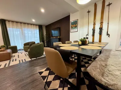 a living room with a dining table and chairs at Granite Ridge Condo by Revelstoke Vacations in Revelstoke