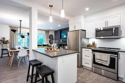a kitchen with white cabinets and a counter top at Revelation Retreat by Revelstoke Vacations in Revelstoke