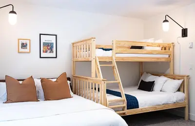 two beds in a room with bunk beds at Revelation Retreat by Revelstoke Vacations in Revelstoke
