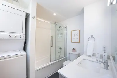 a white bathroom with a shower and a sink at Revelation Retreat by Revelstoke Vacations in Revelstoke