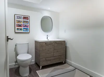 a bathroom with a toilet and a sink and a mirror at Revelation Retreat by Revelstoke Vacations in Revelstoke