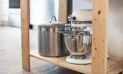 a kitchenaid mixer sitting on a wooden shelf at Niska's Den by Revelstoke Vacations in Revelstoke