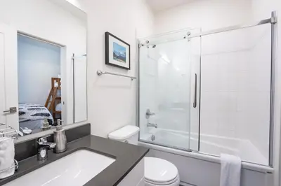a bathroom with a shower and a sink and a toilet at Alpine Escape by Revelstoke Vacations in Revelstoke