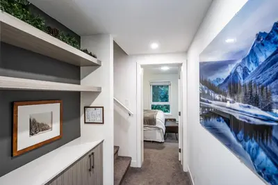a hallway with a painting on the wall at Alpine Escape by Revelstoke Vacations in Revelstoke