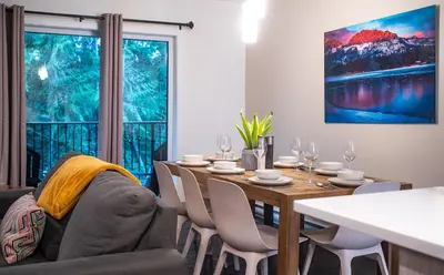 a dining room with a table and chairs and a window at Alpine Escape by Revelstoke Vacations in Revelstoke