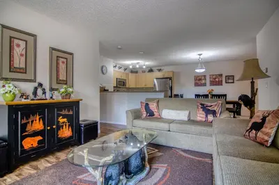 a living room with a couch and a fireplace at Mountain getaway condo - 5 min walk to the beach! in Invermere