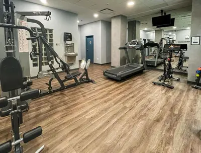 a gym with several treadmills and cardio machines at Alpenglow Lodge Rainbow Look Out Studio by MVA in Whistler