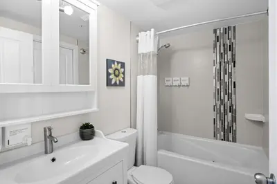 a white bathroom with a sink and a toilet at Alpenglow Lodge Junior Penthouse by MVA in Whistler