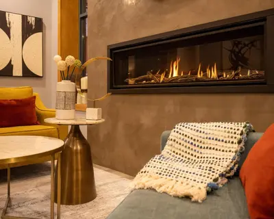 a living room with a fireplace and a couch at Alpenglow Lodge Two Bedroom Apartment by MVA in Whistler