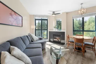 a living room with a couch and a table at Alpenglow Lodge Two Bedroom Apartment by MVA in Whistler