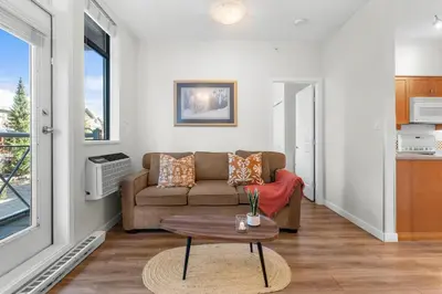 a living room with a couch and a table at Alpenglow Lodge Junior One Bedroom by MVA in Whistler