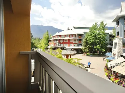 a balcony of a hotel with a view of a courtyard at Bear Lodge Two Bedroom by MVA in Whistler