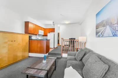 a living room with a couch and a table at Alpenglow Lodge Large Studio with Dedicated Work Space by MVA in Whistler