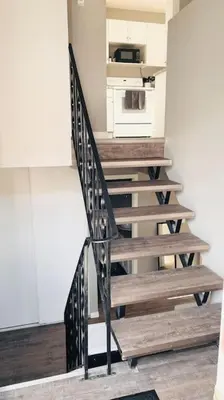 a staircase in a room with a stove at Spacious 2-bedroom apartment in Camrose