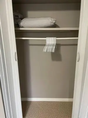 a door to a closet with a bed in it at Spacious 2-bedroom apartment in Camrose