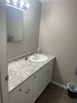 a bathroom with a sink and a mirror at Lovely 2 Bedroom apartment in Camrose