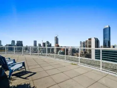 a bench on a roof with a view of a city at Beautiful Downtown Loft with full kitchen in Vancouver