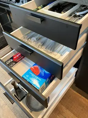 an open refrigerator drawer with a book in it at Beautiful Downtown Loft with full kitchen in Vancouver