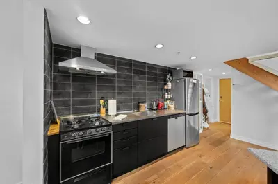 a kitchen with a stove and a refrigerator at Beautiful Downtown Loft with full kitchen in Vancouver